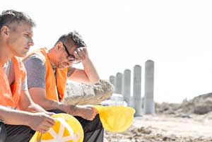 Exhausted construction workers